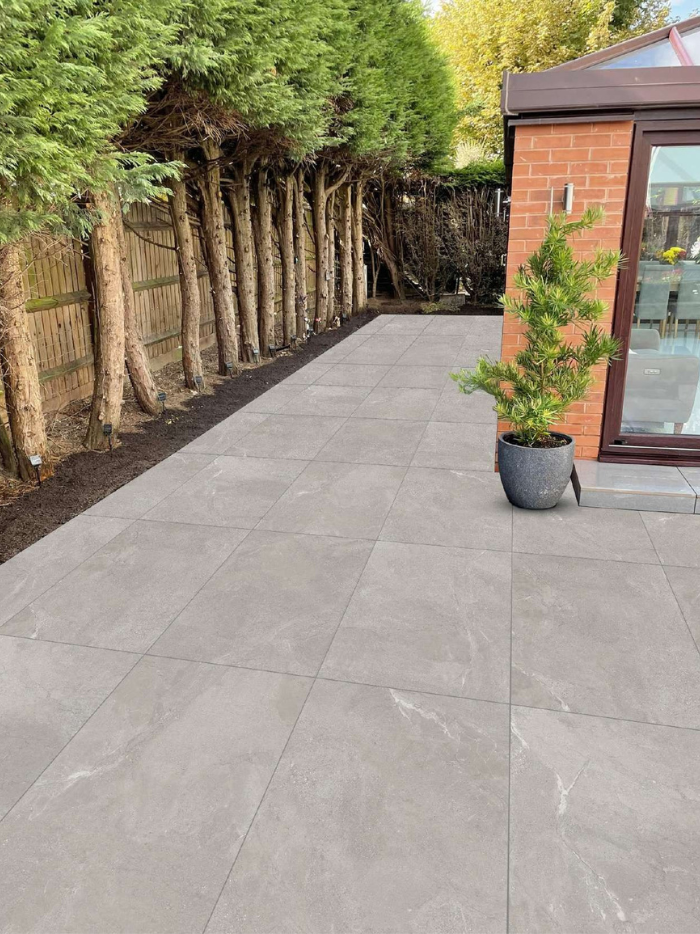 Porcelain outdoor tiles on a modern patio with garden view