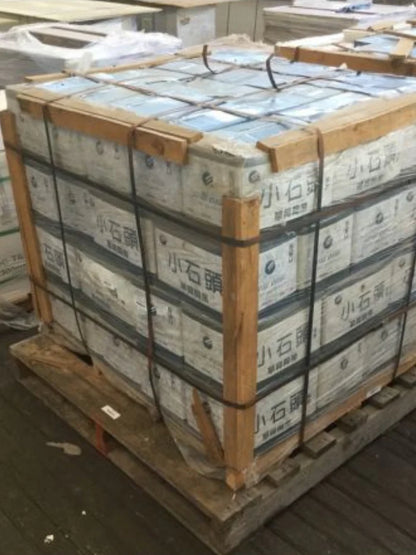 Stack of boxes on a pallet with wooden straps, indoor setting