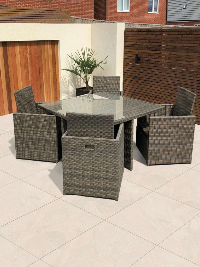 Outdoor patio set with a table and chairs on a tiled patio.