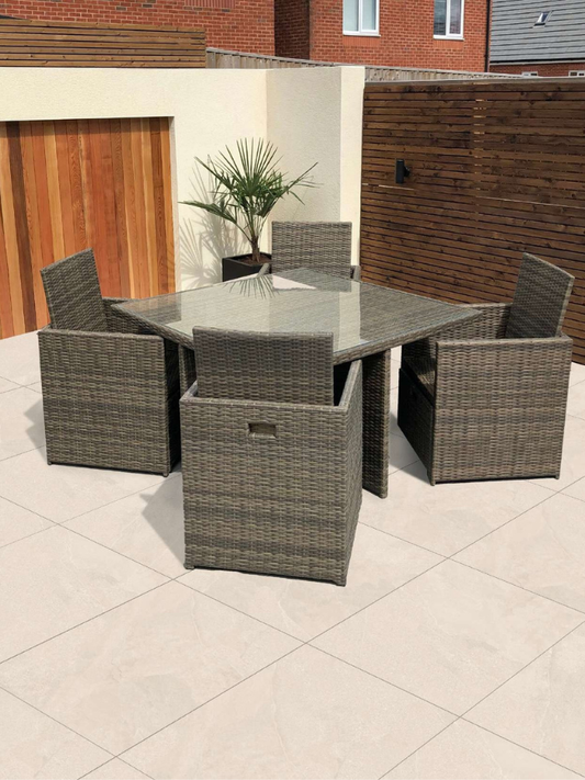 Outdoor patio set with a table and chairs on a tiled patio.