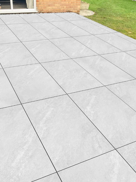 Gray concrete patio with square tiles