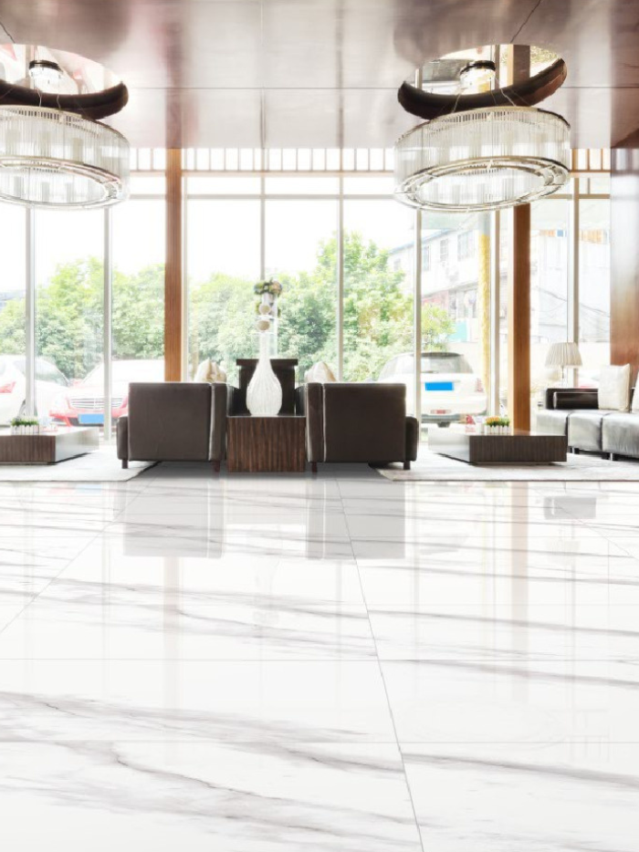 Modern interior design of a lobby with large windows, chairs, and decorative elements.